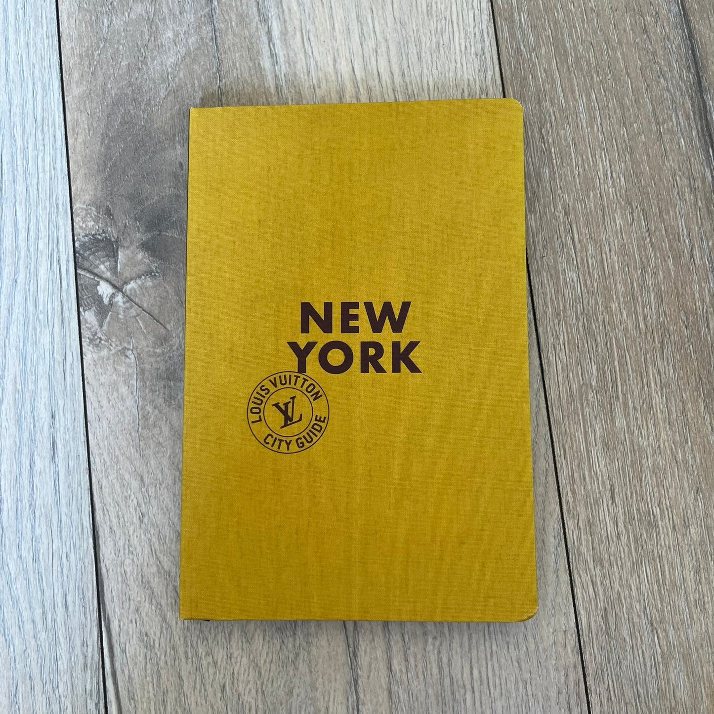 Louis Vuitton “New York” City Guide is an English-language travel book with cloth binding, featuring contributions from writers Carole Sabas, Marie Salomé Peyronnel, Aude Revier, and Fabrice Gaucher. The guide includes special guest contributions from Hank Willis Thomas and Rujeko Hockley, with exclusive photography by Pascal Aimar. It covers New York’s hotels, restaurants, cultural landmarks, and creative hubs, providing curated insights into the city’s art, design, gastronomy, and culture.