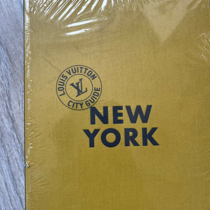 Louis Vuitton “New York” City Guide is an English-language travel book with cloth binding, featuring contributions from writers Carole Sabas, Marie Salomé Peyronnel, Aude Revier, and Fabrice Gaucher. The guide includes special guest contributions from Hank Willis Thomas and Rujeko Hockley, with exclusive photography by Pascal Aimar. It covers New York’s hotels, restaurants, cultural landmarks, and creative hubs, providing curated insights into the city’s art, design, gastronomy, and culture.