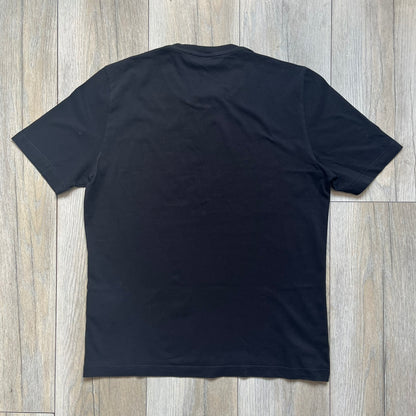 Love Moschino 2010s Carrot Tee is a black and white T-shirt with black sleeves and back panel. The front features Love Moschino branding above two illustrated carrots, with large red “CARROT” text underneath and “Price 20 Cents” text below. The front graphic is designed in the style of a vintage carrot advertisement.
