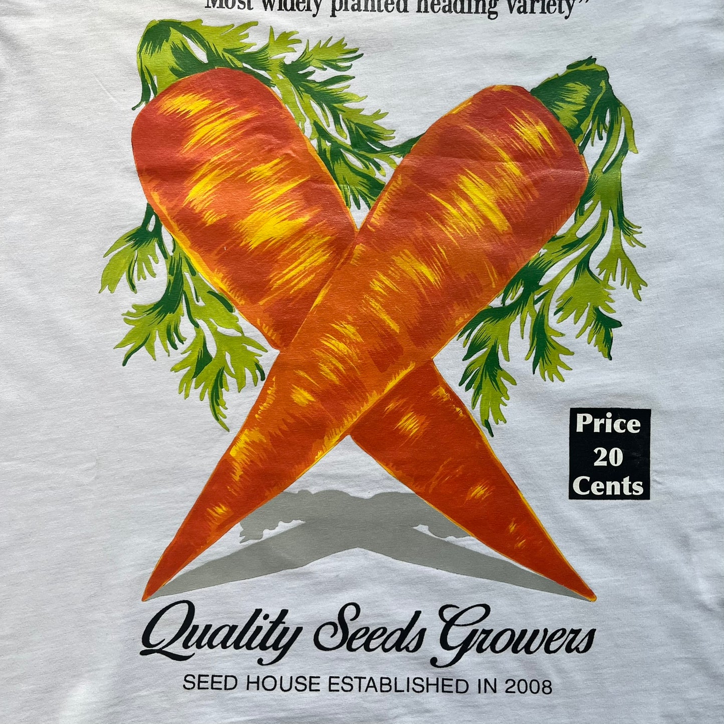 Love Moschino 2010s Carrot Tee is a black and white T-shirt with black sleeves and back panel. The front features Love Moschino branding above two illustrated carrots, with large red “CARROT” text underneath and “Price 20 Cents” text below. The front graphic is designed in the style of a vintage carrot advertisement.

