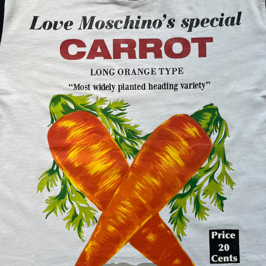 Love Moschino 2010s Carrot Tee is a black and white T-shirt with black sleeves and back panel. The front features Love Moschino branding above two illustrated carrots, with large red “CARROT” text underneath and “Price 20 Cents” text below. The front graphic is designed in the style of a vintage carrot advertisement.
