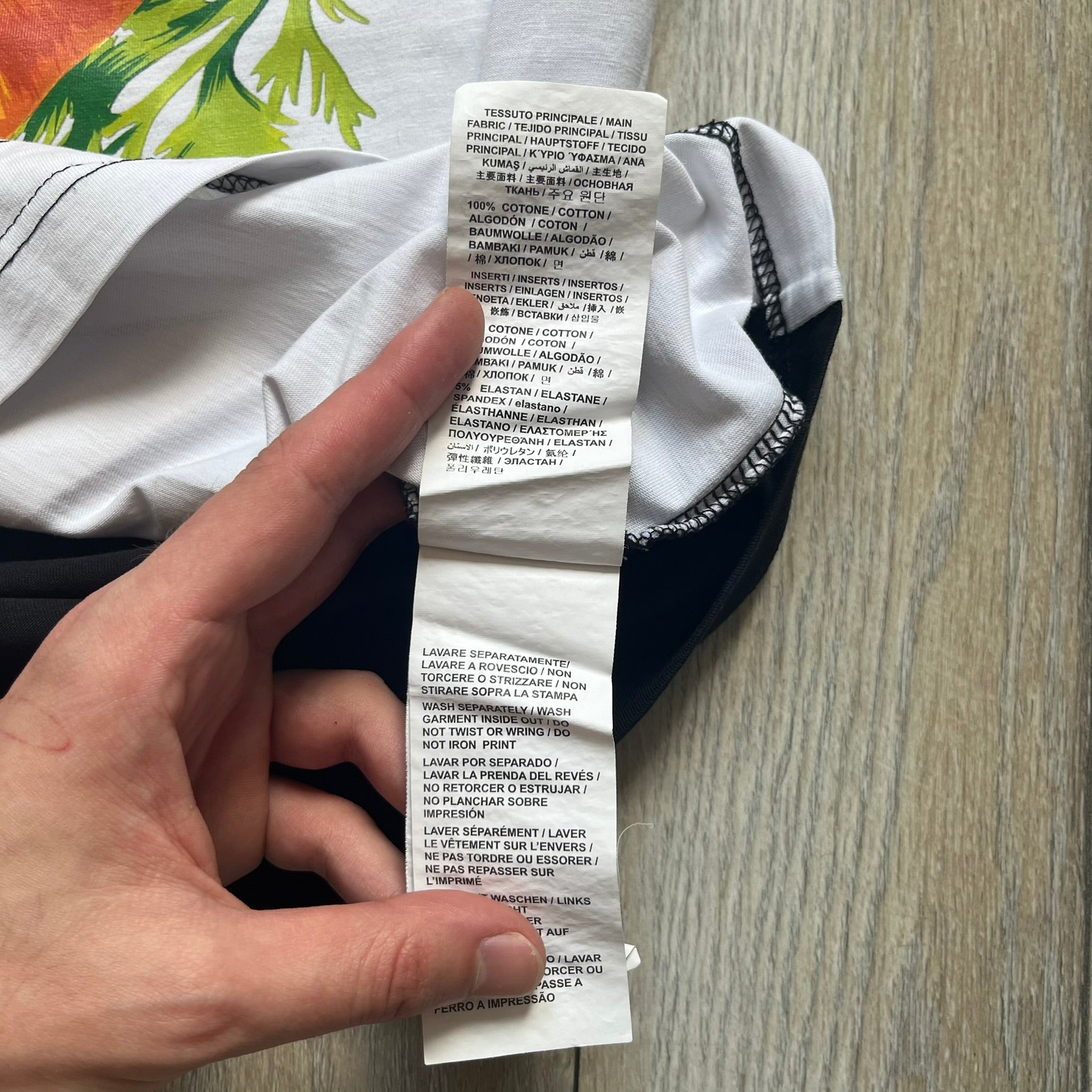 Love Moschino 2010s Carrot Tee is a black and white T-shirt with black sleeves and back panel. The front features Love Moschino branding above two illustrated carrots, with large red “CARROT” text underneath and “Price 20 Cents” text below. The front graphic is designed in the style of a vintage carrot advertisement.
