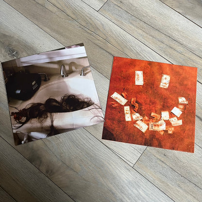 Lucki Drgs R Bad* 2026 Signed BRAZY 4 LUCKI Vinyl is a 2xLP release of Lucki’s fourth studio album, originally released on May 15, 2026. The set includes alternative front and back artwork, a widespine jacket, and printed inner sleeves with different graphics for each record. The vinyl records are transparent orange with black smoke effects throughout. The outer jacket features artwork of a girl shaving her head with the DRB logo cut into her hair. This copy is signed by Lucki in the upper left corner with 