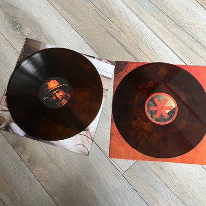 Lucki Drgs R Bad* 2026 Signed BRAZY 4 LUCKI Vinyl is a 2xLP release of Lucki’s fourth studio album, originally released on May 15, 2026. The set includes alternative front and back artwork, a widespine jacket, and printed inner sleeves with different graphics for each record. The vinyl records are transparent orange with black smoke effects throughout. The outer jacket features artwork of a girl shaving her head with the DRB logo cut into her hair. This copy is signed by Lucki in the upper left corner with 