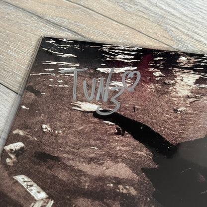 Lucki Dr*gs R Bad 2026 Signed Meet Me @ Viper Room Vinyl is a 2xLP release of Lucki’s fourth studio album, originally released on May 15, 2026. The set includes alternative front and back artwork, a widespine jacket, and printed inner sleeves with different graphics for each record. The vinyl records are transparent black with black smoke effects throughout. The outer jacket features artwork of a person drowning in a pool filled with money. This copy is signed by Lucki in the upper left corner with the insc