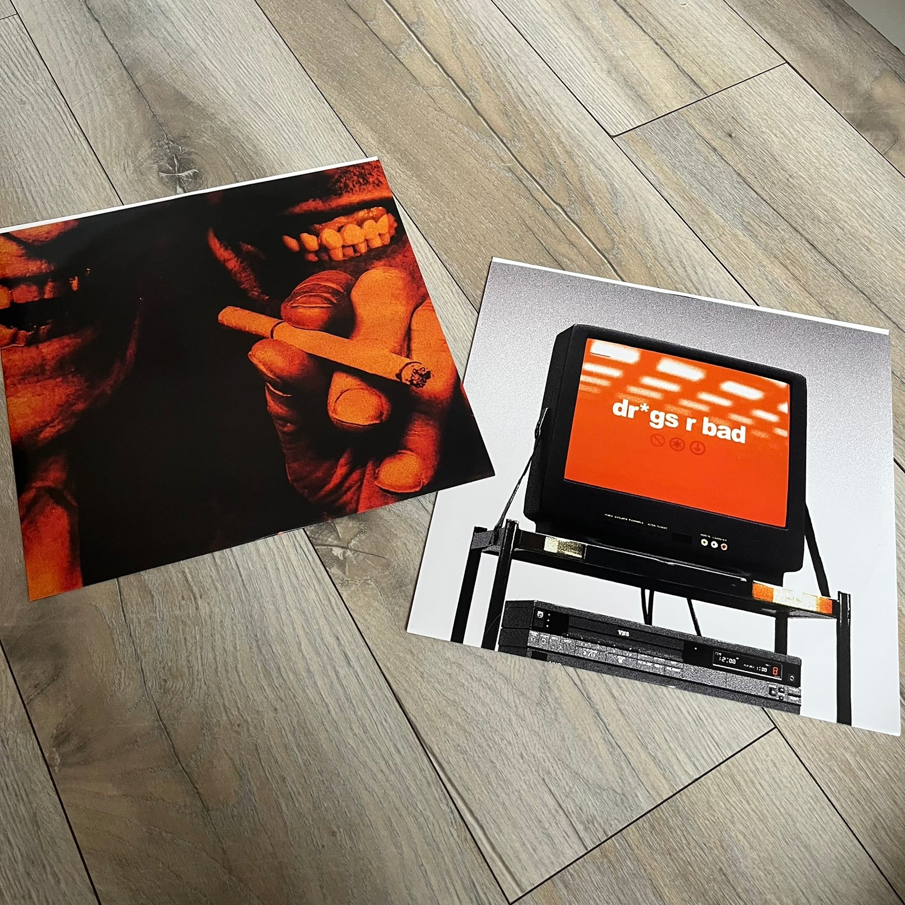 Lucki Dr*gs R Bad 2026 Signed Meet Me @ Viper Room Vinyl is a 2xLP release of Lucki’s fourth studio album, originally released on May 15, 2026. The set includes alternative front and back artwork, a widespine jacket, and printed inner sleeves with different graphics for each record. The vinyl records are transparent black with black smoke effects throughout. The outer jacket features artwork of a person drowning in a pool filled with money. This copy is signed by Lucki in the upper left corner with the insc