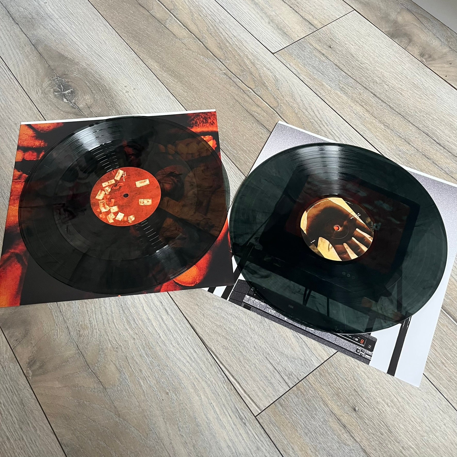 Lucki Dr*gs R Bad 2026 Signed Meet Me @ Viper Room Vinyl is a 2xLP release of Lucki’s fourth studio album, originally released on May 15, 2026. The set includes alternative front and back artwork, a widespine jacket, and printed inner sleeves with different graphics for each record. The vinyl records are transparent black with black smoke effects throughout. The outer jacket features artwork of a person drowning in a pool filled with money. This copy is signed by Lucki in the upper left corner with the insc