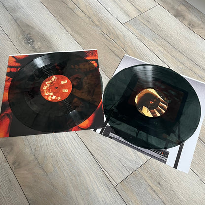 Lucki Dr*gs R Bad 2026 Signed Meet Me @ Viper Room Vinyl is a 2xLP release of Lucki’s fourth studio album, originally released on May 15, 2026. The set includes alternative front and back artwork, a widespine jacket, and printed inner sleeves with different graphics for each record. The vinyl records are transparent black with black smoke effects throughout. The outer jacket features artwork of a person drowning in a pool filled with money. This copy is signed by Lucki in the upper left corner with the insc