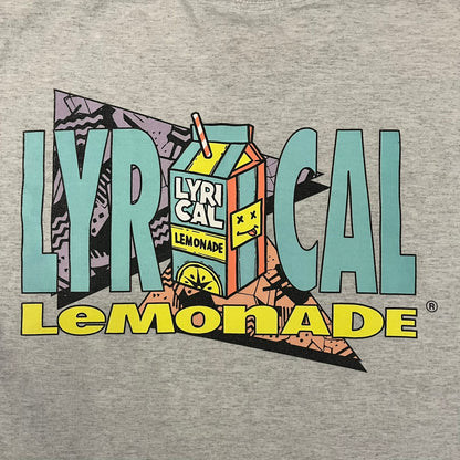 Lyrical Lemonade Everyday Essentials Gray T-Shirt in a gray colorway. Features a small Lyrical Lemonade carton graphic with an xP face printed on the left chest. The back displays a large Lyrical Lemonade logo with text and carton graphics in blue, yellow, and pink, from the Everyday Essentials line.