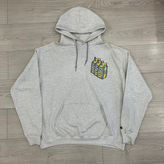 Champion x Lyrical Lemonade Grey Hoodie featuring a triple overlaping lemonade cartoon patch design on the front left chest. Made from a 50/50 cotton-polyester, this medium ash grey hoodie includes a two-ply hood, dyed-to-match drawcord, front pouch pocket, and embroidered Champion logo on the wrist.