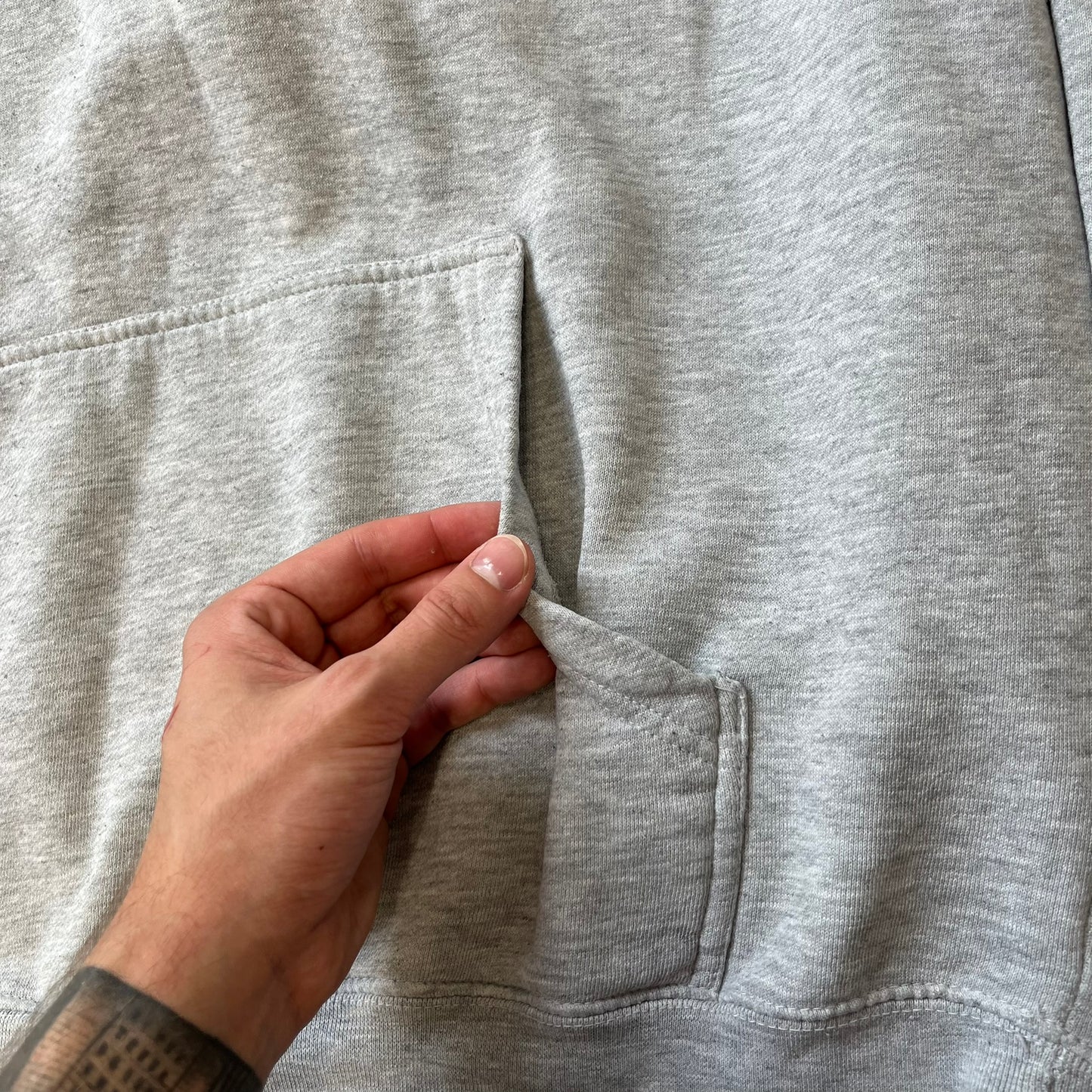 Lyrical Lemonade Triple Patch Gray Hoodie features a gray colorway with a layered triple lemonade box patch design on the left chest in red, yellow, and blue. Made from an 80/20 cotton-polyester blend, the hoodie includes a yellow Lyrical Lemonade neck tag.