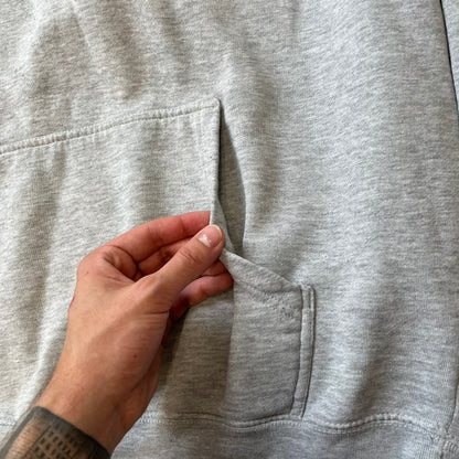 Lyrical Lemonade Triple Patch Gray Hoodie features a gray colorway with a layered triple lemonade box patch design on the left chest in red, yellow, and blue. Made from an 80/20 cotton-polyester blend, the hoodie includes a yellow Lyrical Lemonade neck tag.