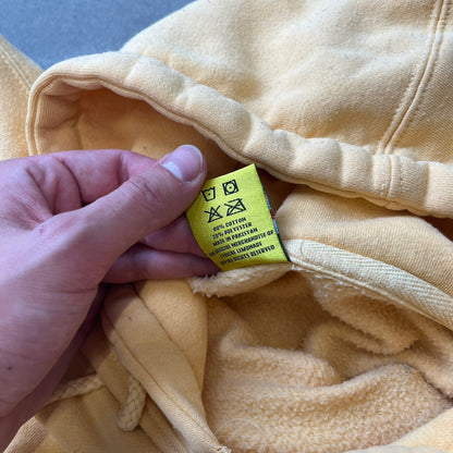 Lyrical Lemonade Triple Patch Yellow Hoodie features a yellow colorway with a layered triple lemonade box patch design on the left chest in red, yellow, and blue. Made from an 80/20 cotton-polyester blend, the hoodie includes a yellow Lyrical Lemonade neck tag.