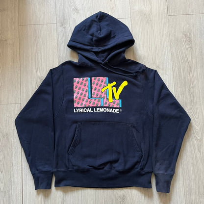 Lyrical Lemonade x MTV hoodie made on a Champion Reverse Weave blank. The front features a large pink Lyrical Lemonade “LL” logo based on MTV, filled with lemonade carton graphics, and white “Lyrical Lemonade” text printed underneath. Constructed with Champion’s heavyweight Reverse Weave fabric, finished with ribbed side panels and a small embroidered Champion logo on the sleeve near the hem.