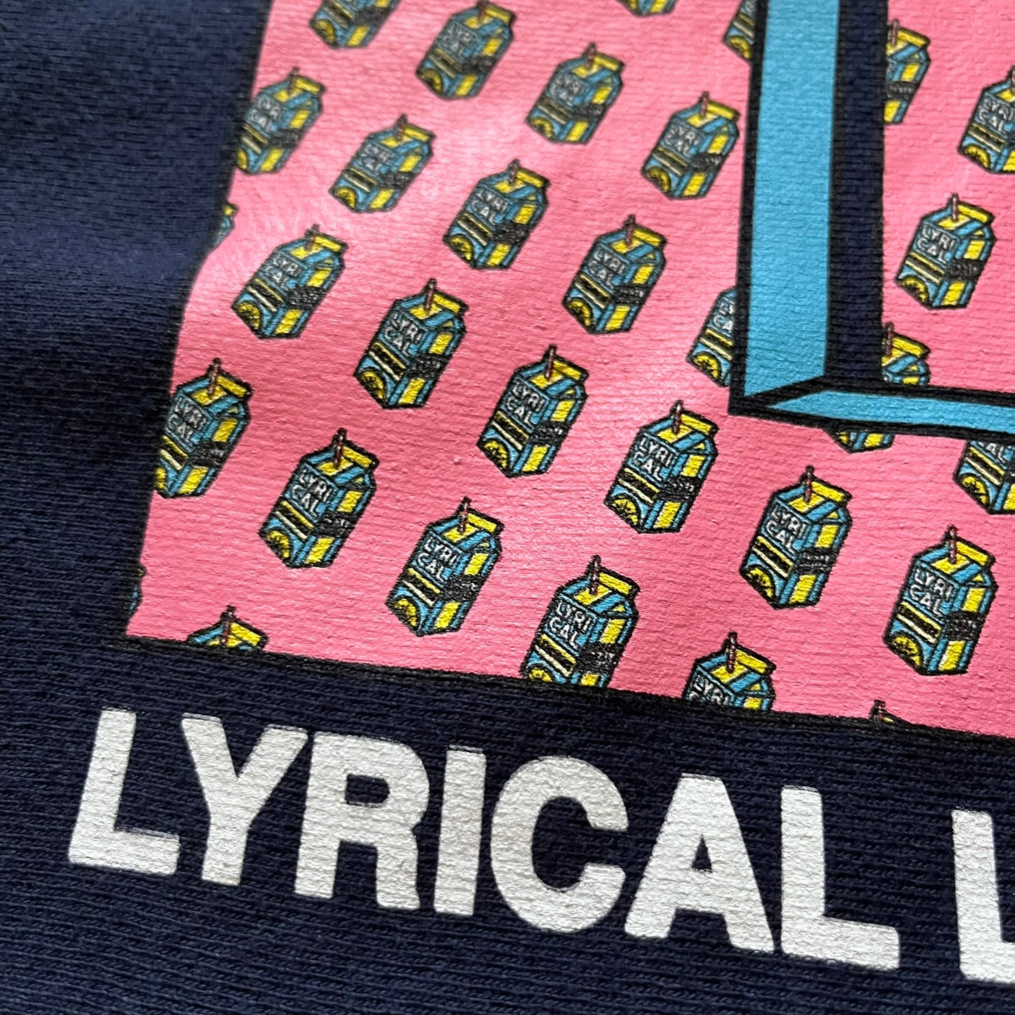 Lyrical Lemonade x MTV hoodie made on a Champion Reverse Weave blank. The front features a large pink Lyrical Lemonade “LL” logo based on MTV, filled with lemonade carton graphics, and white “Lyrical Lemonade” text printed underneath. Constructed with Champion’s heavyweight Reverse Weave fabric, finished with ribbed side panels and a small embroidered Champion logo on the sleeve near the hem.