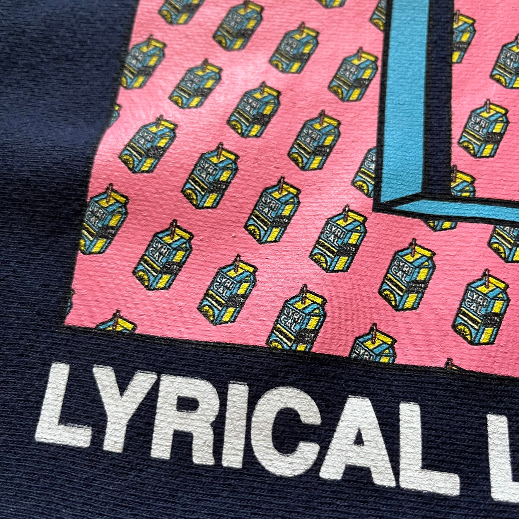 Lyrical Lemonade x MTV hoodie made on a Champion Reverse Weave blank. The front features a large pink Lyrical Lemonade “LL” logo based on MTV, filled with lemonade carton graphics, and white “Lyrical Lemonade” text printed underneath. Constructed with Champion’s heavyweight Reverse Weave fabric, finished with ribbed side panels and a small embroidered Champion logo on the sleeve near the hem.