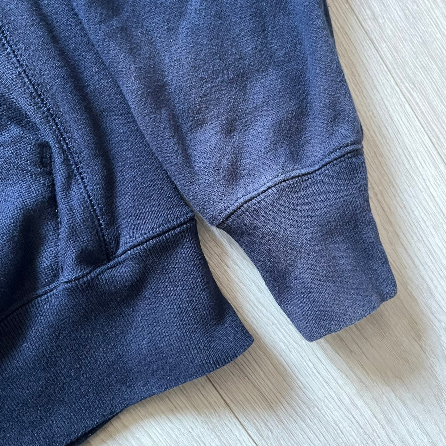 Lyrical Lemonade x MTV hoodie made on a Champion Reverse Weave blank. The front features a large pink Lyrical Lemonade “LL” logo based on MTV, filled with lemonade carton graphics, and white “Lyrical Lemonade” text printed underneath. Constructed with Champion’s heavyweight Reverse Weave fabric, finished with ribbed side panels and a small embroidered Champion logo on the sleeve near the hem.