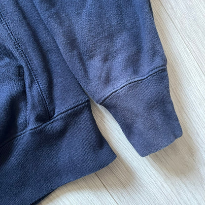 Lyrical Lemonade x MTV hoodie made on a Champion Reverse Weave blank. The front features a large pink Lyrical Lemonade “LL” logo based on MTV, filled with lemonade carton graphics, and white “Lyrical Lemonade” text printed underneath. Constructed with Champion’s heavyweight Reverse Weave fabric, finished with ribbed side panels and a small embroidered Champion logo on the sleeve near the hem.