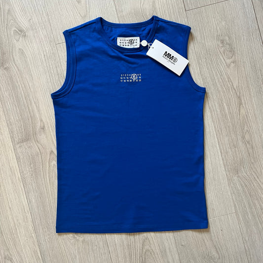 Blue sleeveless top with tags on a wooden floor