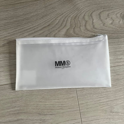 Clear pouch with MM6 Maison Margiela logo on a wooden surface