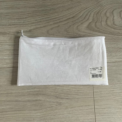White zippered pouch with a label on a wooden surface