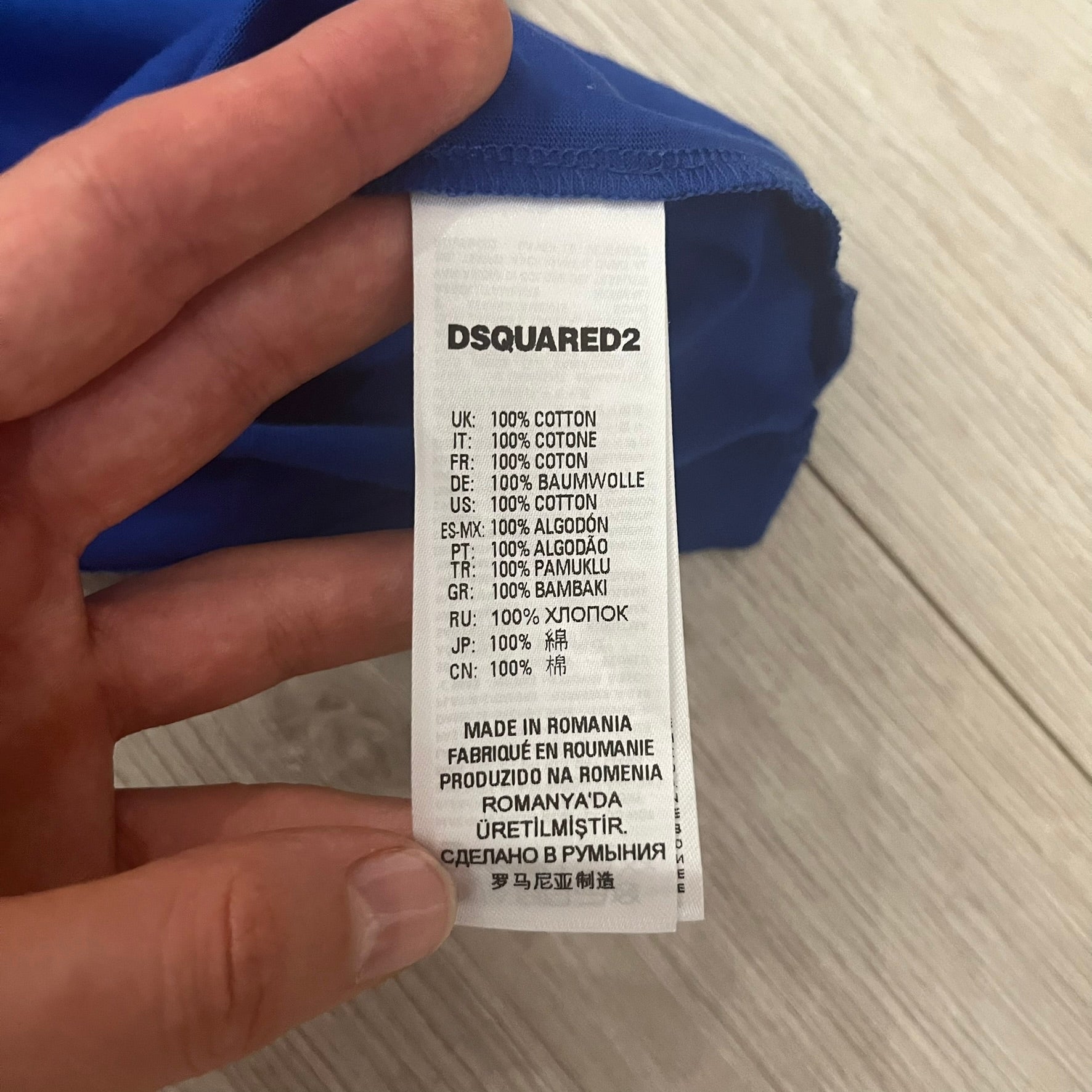 Dsquared2 label on a blue garment with text details