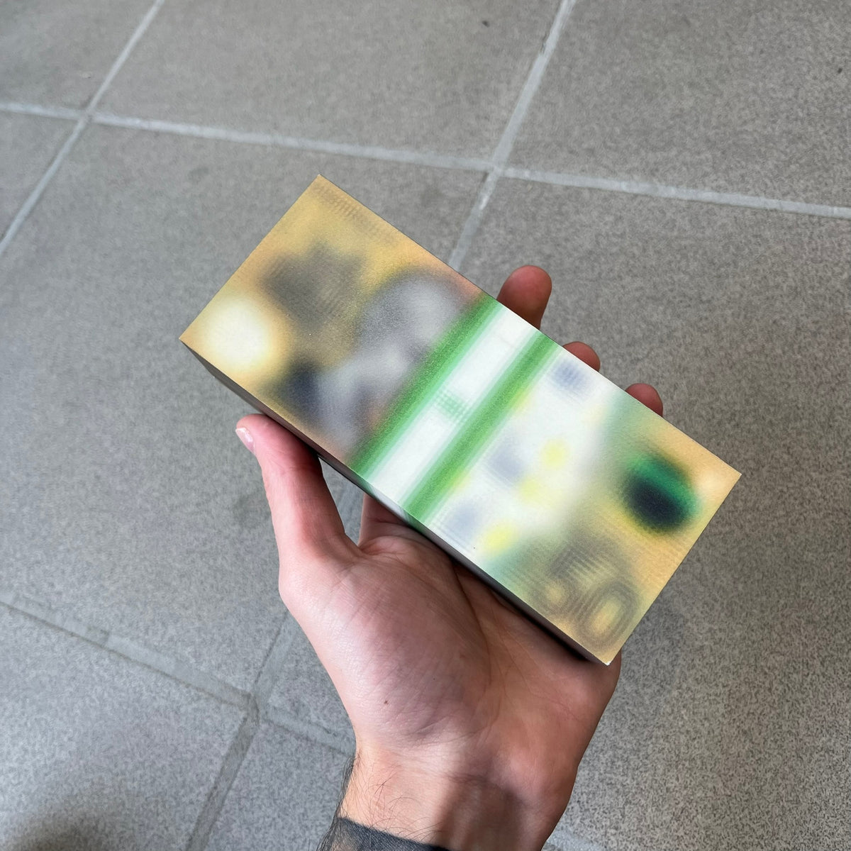 MSCHF Blur A$50 AUD Figure released on May 24rd 2022. The collectible object is designed as a stack of 50 Australian Dollars banknotes with a blurred sculptural effect across the entire surface. The piece recreates the appearance of a money stack while distorting the printed details, giving it a block-like form resembling a stylized or game-like currency bundle.