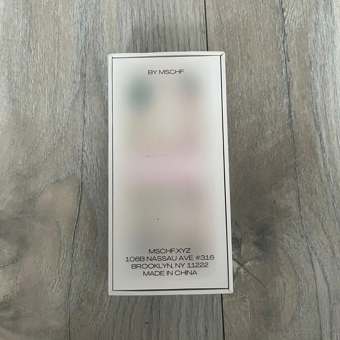 MSCHF Blur د.إ 100 Dirham Figure is an art object released on March 14, 2022, as part of MSCHF’s Blur series. The piece replicates a 100 UAE dirham banknote in a deliberately blurred physical form, continuing the concept of “ecommerce performance art” where the product appears visually obscured both online and in reality. It was released as part of the Spring/Summer 2022 lineup