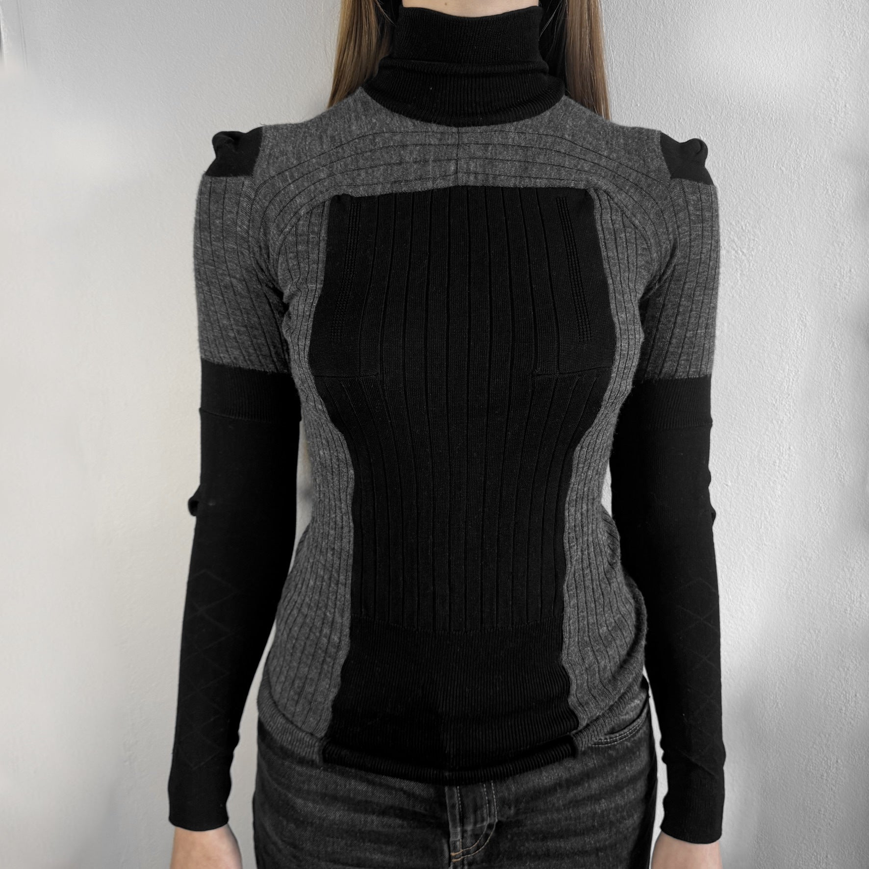 Maison Margiela x H&amp;M AW12 wool sweater in gray and black, designed with stretch fabric for a snug, comfortable fit. Features sock-inspired panels with heel details on the shoulders and elbows, a turtleneck, and long sleeves. A standout piece from the 2012 collaboration, inspired by Margiela’s Fall 1989 collection.
