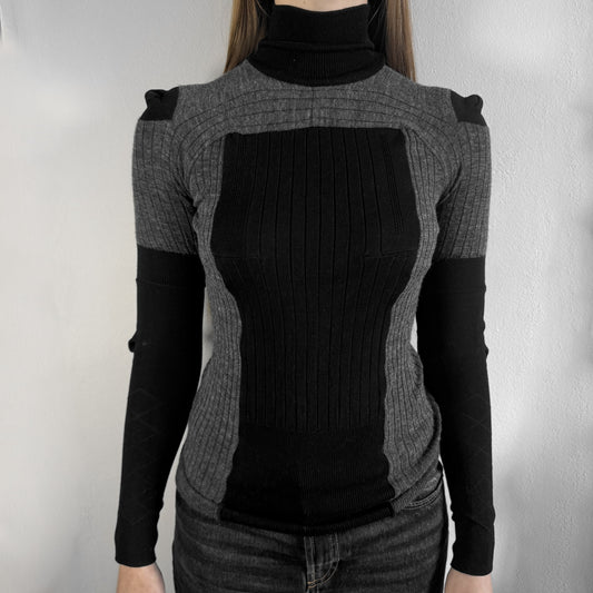 Maison Margiela x H&amp;M AW12 wool sweater in gray and black, designed with stretch fabric for a snug, comfortable fit. Features sock-inspired panels with heel details on the shoulders and elbows, a turtleneck, and long sleeves. A standout piece from the 2012 collaboration, inspired by Margiela’s Fall 1989 collection.