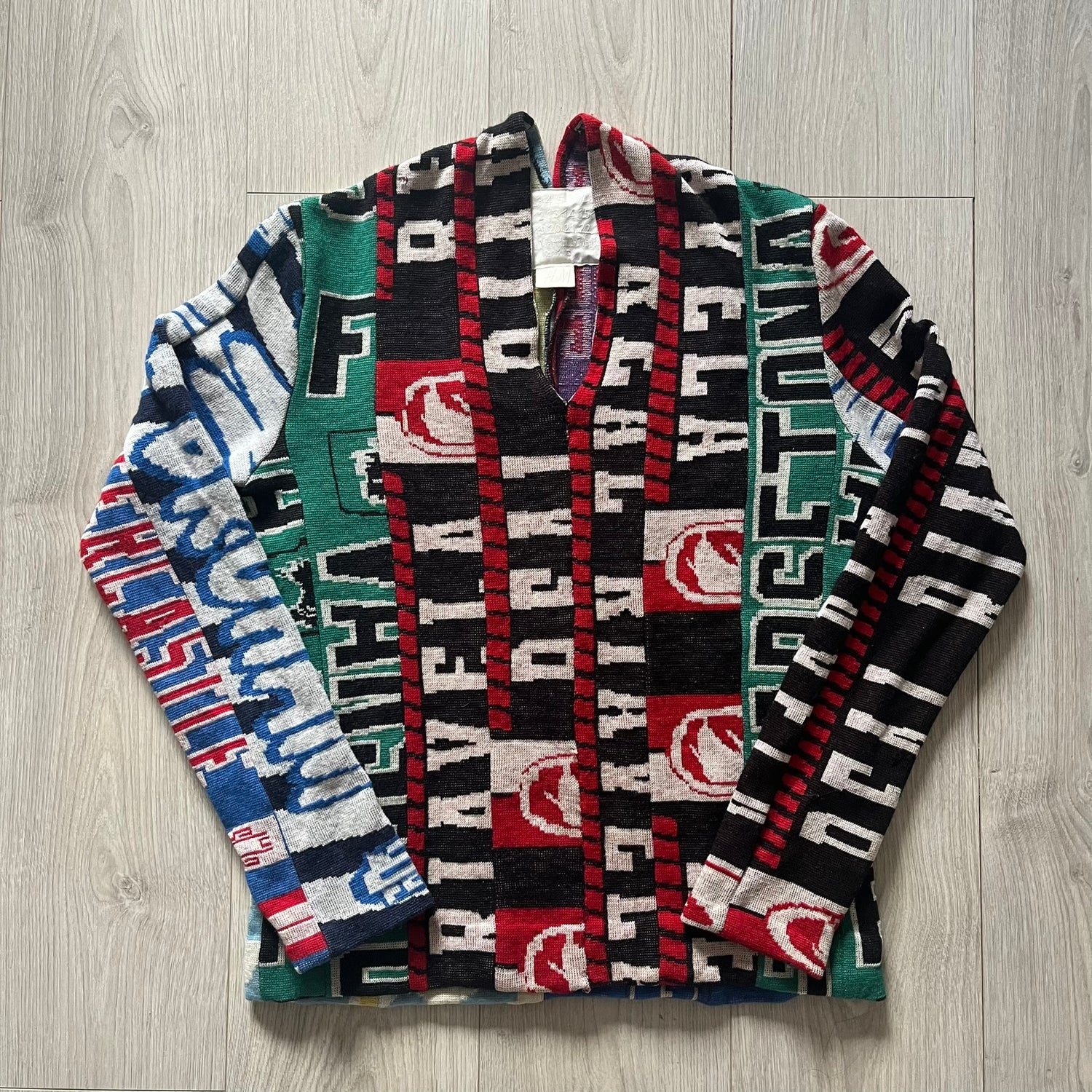 Collection of patterned scarves with visible branding on a wooden surface