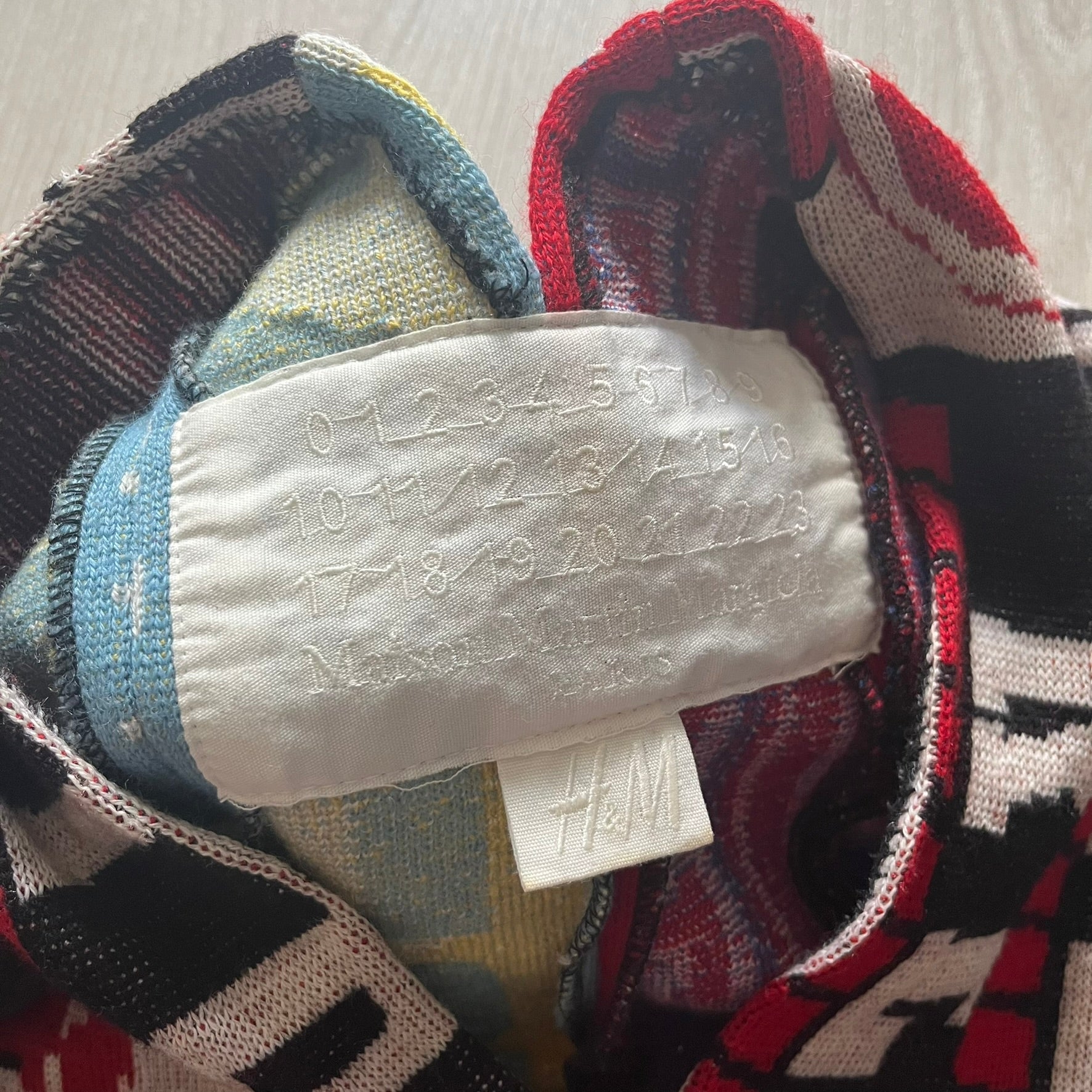 Colorful fabric with an H&M label on a neutral background