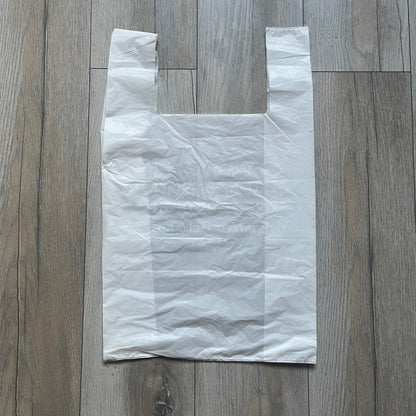 Clear/white plastic bag from the Maison Margiela x H&amp;M collaboration, designed with a cut-off bottom that allows it to be worn as a top or tank. Features big Maison Margiela x H&amp;M logos printed on the front, visible through the semi-transparent material.