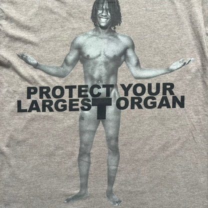 Marc Jacobs 2010s “Protect Your Largest Organ” Chico Clark T-shirt is a light brown awareness campaign tee created to support skin cancer prevention initiatives. The front features an artistic illustration of Chico Clark with accompanying “Protect Your Largest Organ” text. The sleeves include printed details referencing the collaboration and support for NYU School of Medicine. The back displays a large “Thank You” message with credits to contributors involved in the campaign.