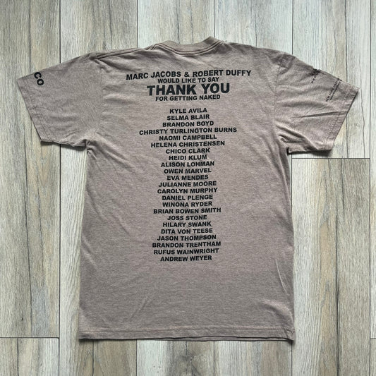 Marc Jacobs 2010s “Protect Your Largest Organ” Chico Clark T-shirt is a light brown awareness campaign tee created to support skin cancer prevention initiatives. The front features an artistic illustration of Chico Clark with accompanying “Protect Your Largest Organ” text. The sleeves include printed details referencing the collaboration and support for NYU School of Medicine. The back displays a large “Thank You” message with credits to contributors involved in the campaign.