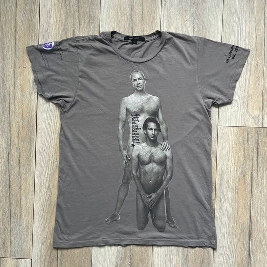 Marc Jacobs 2010s Robert Duffy Skin Cancer Awareness T-shirt is a gray campaign tee created to support skin cancer awareness. The front features an illustrative composition of Robert Duffy with Marc Jacobs included in the design. The sleeves contain printed text referencing “In loving memory of Dr Jessie Rubin” and support for NYU School of Medicine. The back includes a large “Thank You” message listing contributors involved in the campaign.
