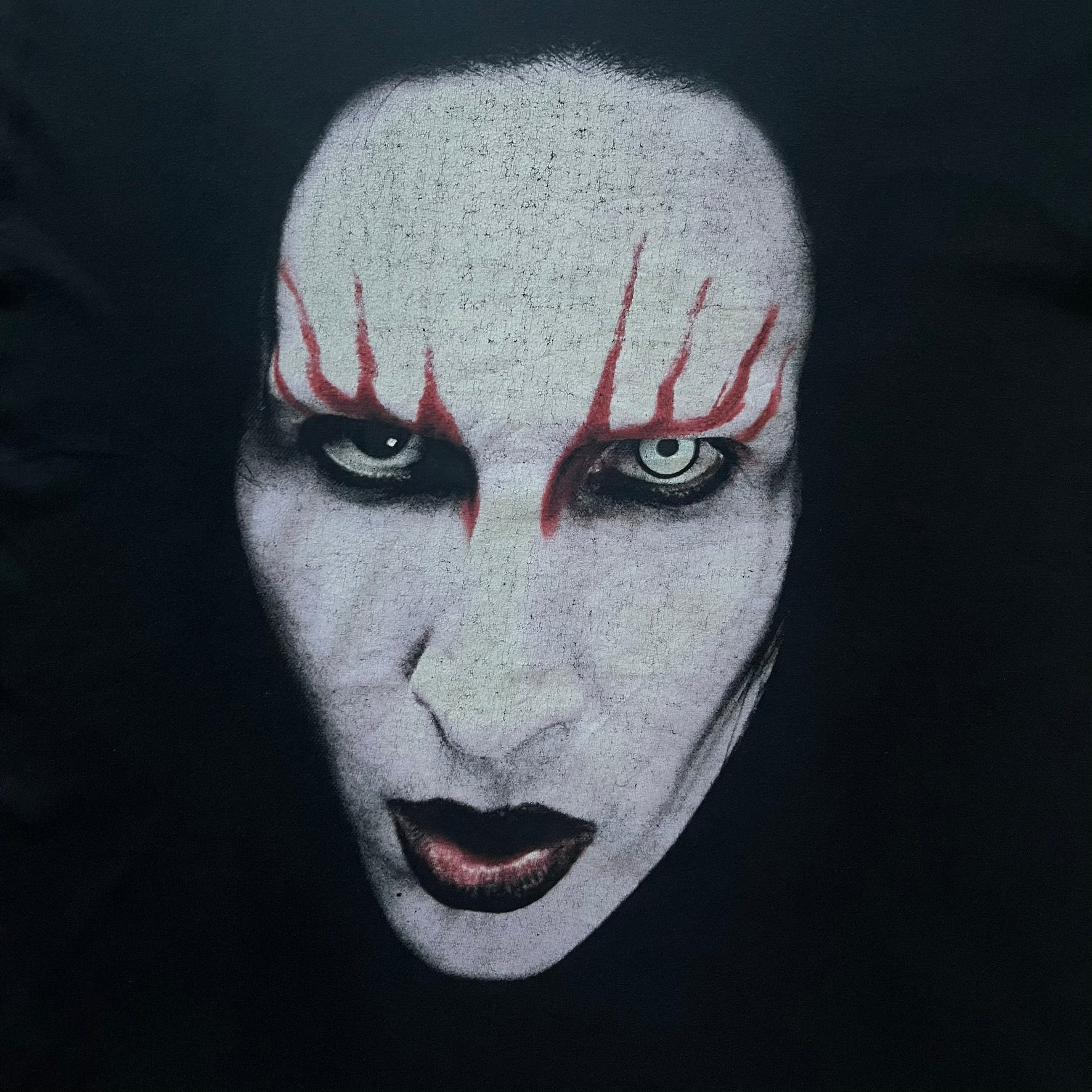 Marilyn Manson Holy Wood Face Tee from 2000, made on a black BG blank. Features a large front graphic of Manson’s face with signature white makeup, red accents, and eye contact. The back includes red Marilyn Manson text with a small 2000 Giant license, great piece from the Holy Wood era.