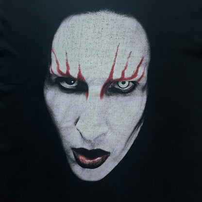 Marilyn Manson Holy Wood Face Tee from 2000, made on a black BG blank. Features a large front graphic of Manson’s face with signature white makeup, red accents, and eye contact. The back includes red Marilyn Manson text with a small 2000 Giant license, great piece from the Holy Wood era.