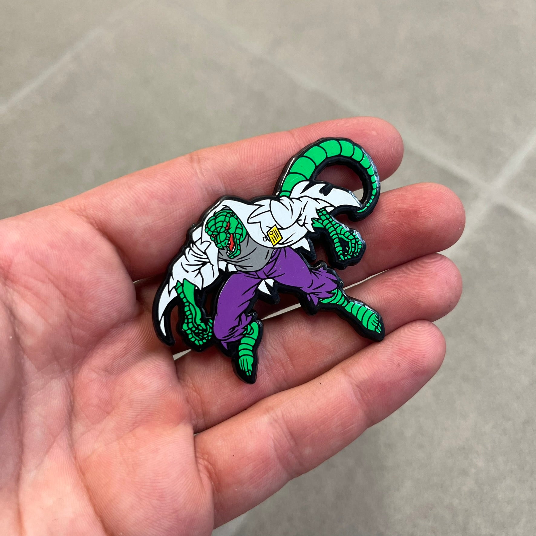 Marvel 1995 The Lizard Pin features a colorful 2D cartoon-style depiction of The Lizard (Dr. Curtis Connors). The back is black with official 1995 Marvel licensing and includes a standard pin fastening.
