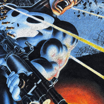 Black Marvel T-shirt from 2002 featuring artwork from The Punisher Limited Series (1985) illustrated by Mike Zeck and Phil Zimelman. The large front graphic shows The Punisher firing a minigun with bullets flying across the scene, based on the original comic poster artwork. Produced on a Hanes Heavyweight blank with a Marvel 2002 sleeve tag and Raphitti branding.