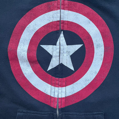 Black hoodie with a large Captain America shield graphic on the front. Made from an 80/20 polyester blend, lightweight. Features metal zipper, front pockets, and WeLoveFine × Marvel neck tag. The shield graphic has an intentional rough texture.