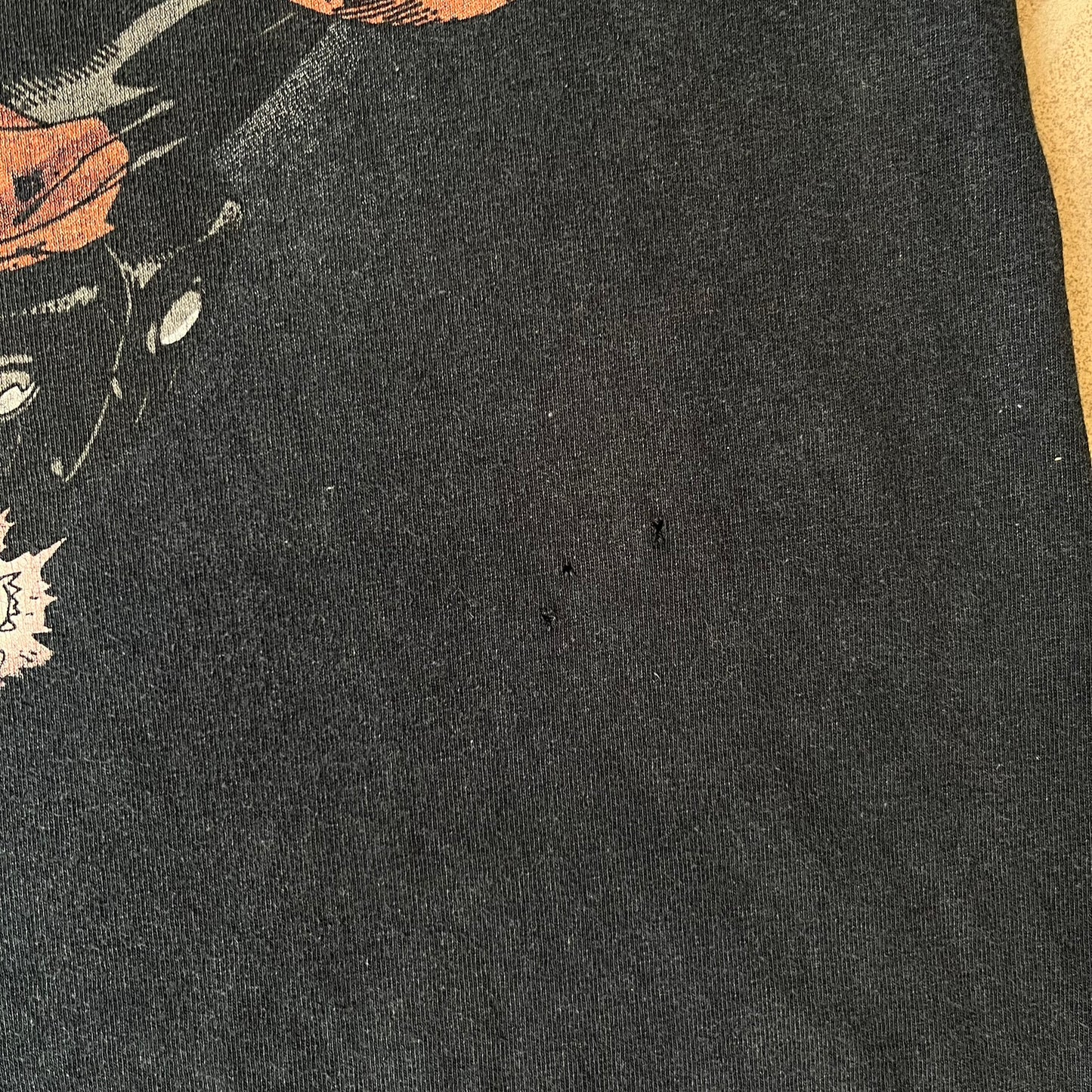 Marvel Mad Engine 2000's Deadpool Tee features a black T-shirt made by Mad Engine. The front has a comic-style graphic of Deadpool in mid-air firing two pistols, with bullets and bullet holes shown throughout the design.
