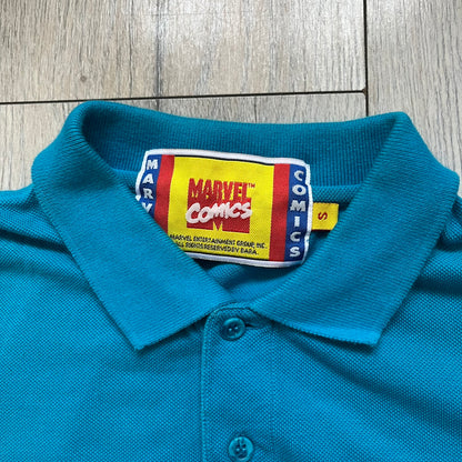 Marvel Comics Spider-Man 1994 Blue Embroidered Polo is a blue polo shirt featuring embroidered Spider-Man branding. The left chest displays an embroidered Spider-Man graphic, while the sleeve includes yellow “Spider-Man” text embroidery. The lower front is finished with small black “1994” text, and the shirt includes a large Marvel Comics neck tag.