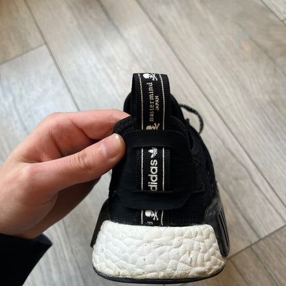 Mastermind x adidas NMD XR1 “Mastermind” Sneakers BA9726 are a 2016 collaboration between adidas and Mastermind Japan, the Japanese label founded by Masaaki Homma. The sneaker features a Core Black/Core Black/White colorway with a polyester mesh upper, rubber sole, and adidas Boost midsole. Mastermind’s signature skull and crossbones logo appears on the leather cage and tongue, while the pair includes black laces and follows the NMD XR1 silhouette released on September 20, 2016 under style code BA9726