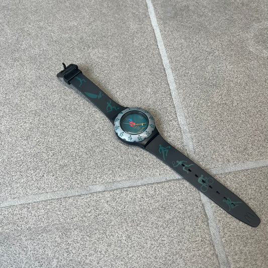McDonald's 1996 Atlanta Olympics Analog Watch features a black strap decorated with green sports-themed figures and a silver and grey case. The green dial has the Atlanta 1996 Olympic Games logo at the center. A vintage McDonald's promotional watch from the 1996 Atlanta Olympics.
