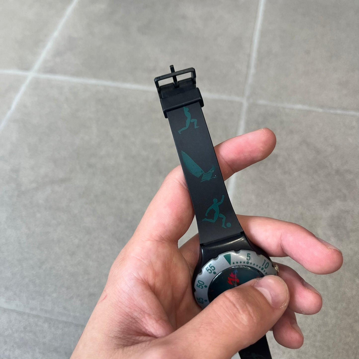 McDonald's 1996 Atlanta Olympics Analog Watch features a black strap decorated with green sports-themed figures and a silver and grey case. The green dial has the Atlanta 1996 Olympic Games logo at the center. A vintage McDonald's promotional watch from the 1996 Atlanta Olympics.

