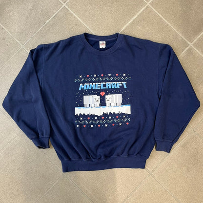 Minecraft Polar Bears Navy Crewneck features a navy construction made on a Fruit of the Loom blank. The front has a pattern of hearts and polar bear heads, with an icy Minecraft logo topped with snow and two polar bears standing on snow with a heart between them. This is not an official Minecraft piece.
