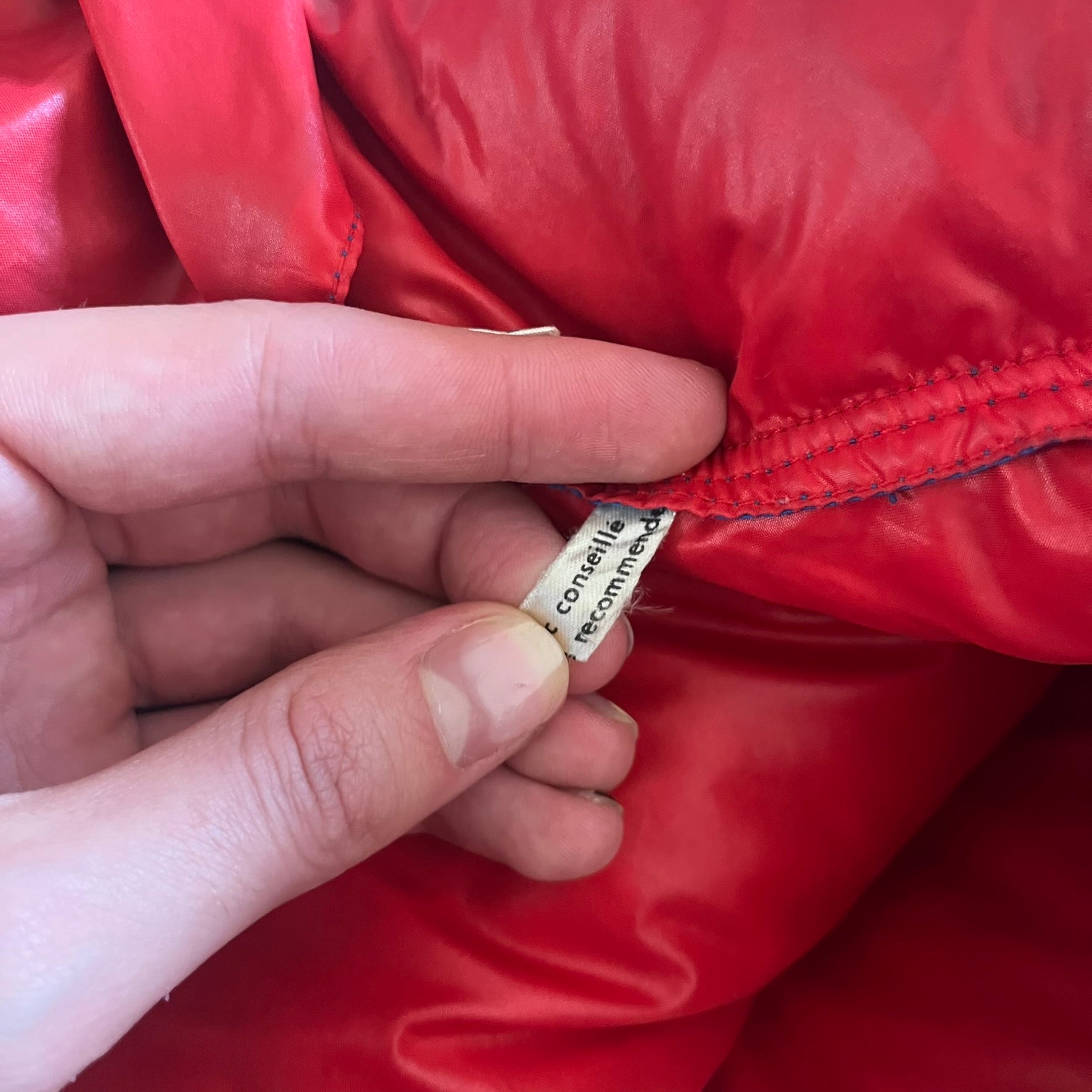 Vintage 1980s Moncler Grenoble down jacket in blue with a contrasting red lining. Features a foldable thin hood hidden in the back, silver-tone buttons and zippers, and the original Moncler patch on the sleeve. A rare French-made piece with authentic Grenoble labels, distinct from the brand’s modern ski line.