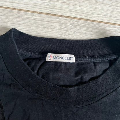 Moncler x Adidas Originals Longsleeve from the FW23 collection. Crafted in cotton jersey, the piece features a three-panel color-block design transitioning from beige to black tones. It includes a silicone chest logo, black Adidas stripes down the sleeves, and a co-branded Moncler x Adidas logo patch on the arm.