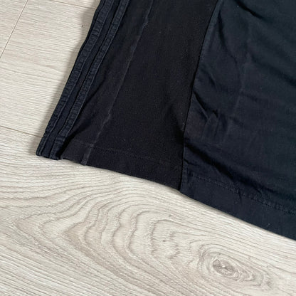 Moncler x Adidas Originals Longsleeve from the FW23 collection. Crafted in cotton jersey, the piece features a three-panel color-block design transitioning from beige to black tones. It includes a silicone chest logo, black Adidas stripes down the sleeves, and a co-branded Moncler x Adidas logo patch on the arm.